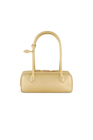 The Reese Metallic Leather Bag - Gold is a rectangular statement handbag in light yellow, featuring two long handles and gold-tone hardware, displayed against a white background.