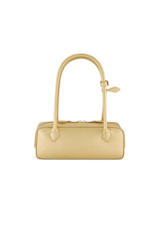 The Reese Metallic Leather Bag - Gold is a rectangular statement handbag with metallic gold finish, two long handles, gold hardware, and a zipper closure, shown against a plain white background.