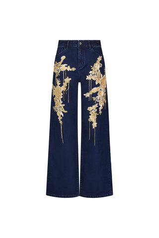 Rocco Gold Embellished Jean - Indigo: high-waisted, wide leg jeans in dark blue stretch denim with bold gold floral embroidery on the front of both legs, shown against a white background.