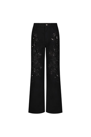 The Stassi Floral Sequin Jean - Black is a high-rise, black wide-leg stretch denim with intricate black floral embroidery and sequin details on the front, displayed against a plain white background.