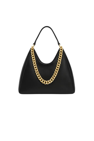 The Tribeca Chain Leather Bag - Black features a sculptural silhouette, short handle, and bold gold chain detail on the front. Shown on a white background.