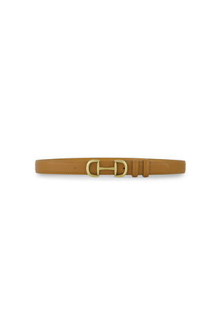 The Bettie Belt - Mocha is a tan pebbled faux leather belt with a gold-toned buckle, featuring a smooth texture, minimal stitching, and subtle horsebit accents. Displayed against a white background, it boasts an elegant, simple design.