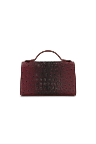 The Danica Ostrich Clutch – Merlot is a structured, burgundy handbag with a top handle and an embossed ostrich pattern, shown against a white background.