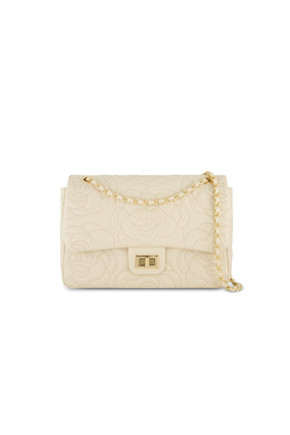 The Alessia Rose Embossed Leather Bag - Pearl is a chain strap handbag with a gold rectangular clasp and an elegant floral embossed design.