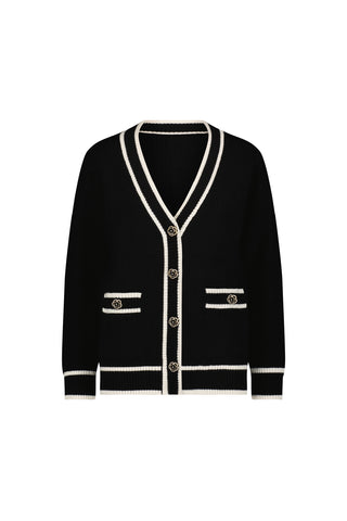 The Devin Rose Contrast Cardigan - Black features white trim, a deep V-neck, gold front buttons, two front pockets, and white accents on the cuffs, hem, and pocket edges.