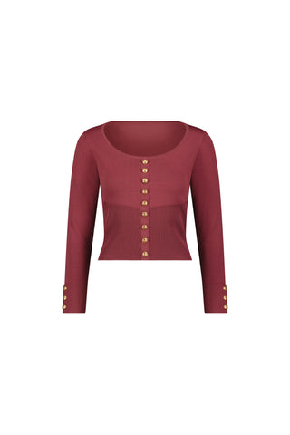 The Edie Knit Top in Sangria is a maroon, long-sleeve cropped cardigan made from lightweight knit with gold buttons on the front and sleeves, shown against a white background.