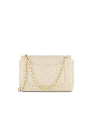 The Alessia Rose Embossed Leather Bag - Pearl is a rectangular cream handbag with floral embossing, a gold chain strap, and a chic flap closure.