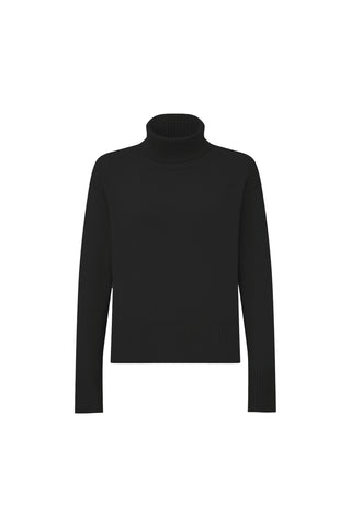 The Gia Ultra Soft Sweater in black features a long-sleeve, oversized turtleneck design with ribbed cuffs, hem, and collar, and a relaxed tunic silhouette, shown against a plain white background.
