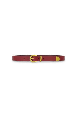 The Jamie Belt - Merlot is a slim, red faux leather belt featuring gold hardware and a gold tip, shown on a white background—a timeless wardrobe staple.