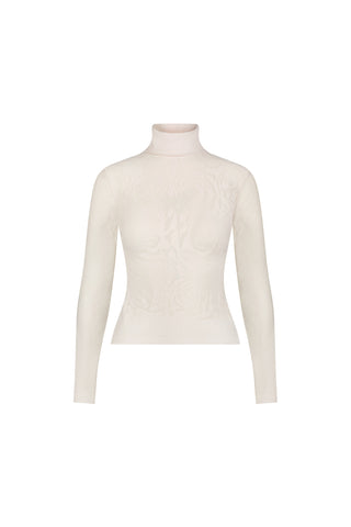The Alina Rose Turtleneck Top - Pearl is a slim-fitting, cream long-sleeve top with a delicate rose motif knit lace on the front, shown on a plain white background.