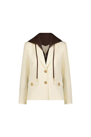 The Kara Dickey Blazer - Pearl/Espresso features a cream hue, gold buttons, dark brown detachable hooded dickey with drawstrings, two front pockets, and a tailored fit. Shown on a plain white background.