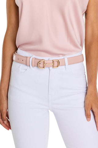 A person wearing a light pink sleeveless top with high-waisted white jeans, accessorized with the Bettie Belt - Blush, a pebbled faux leather belt featuring a gold-toned buckle. The focus is on the waist and torso.