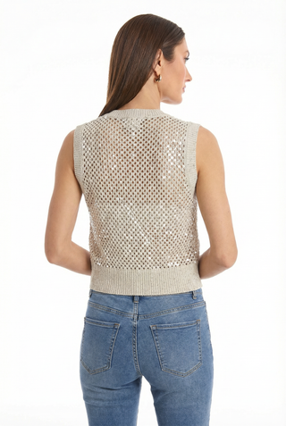 A woman with straight brown hair, gold hoop earrings, and light blue jeans wears the resort-ready sleeveless Addison Sequin Crochet Top - Pearl, shown from the back against a white background.
