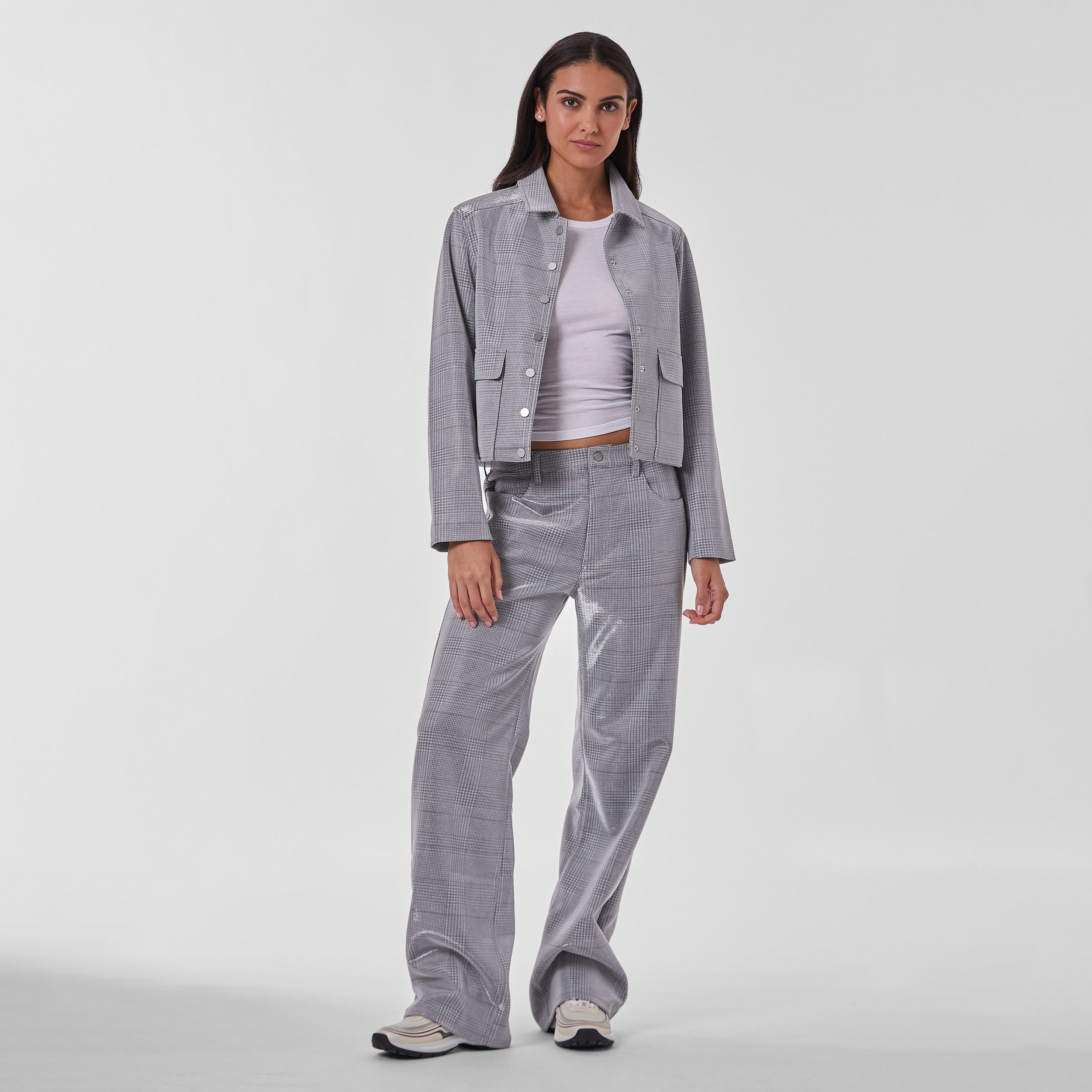 Woman wearing silver plaid patterned cropped jacket and matching pants.
