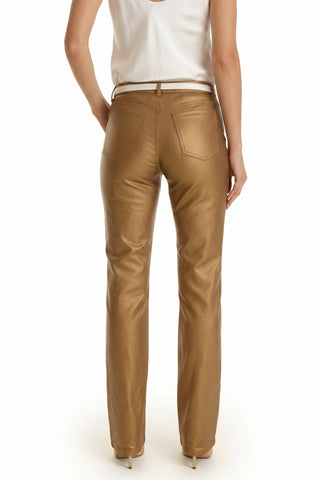 A person is shown from the back wearing the Aria Coated Flare Jean in Gold Metallic and a white sleeveless top, standing on white high heels against a plain white background.