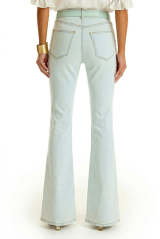 A person is shown from the back wearing Aria Flare Jean - Cloud and a white top, accessorized with a gold bracelet on their right wrist.