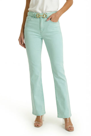 Someone wears the Aria Flare Jean - Mint, styled with a matching belt, white top, and clear-heeled sandals, standing against a white background.