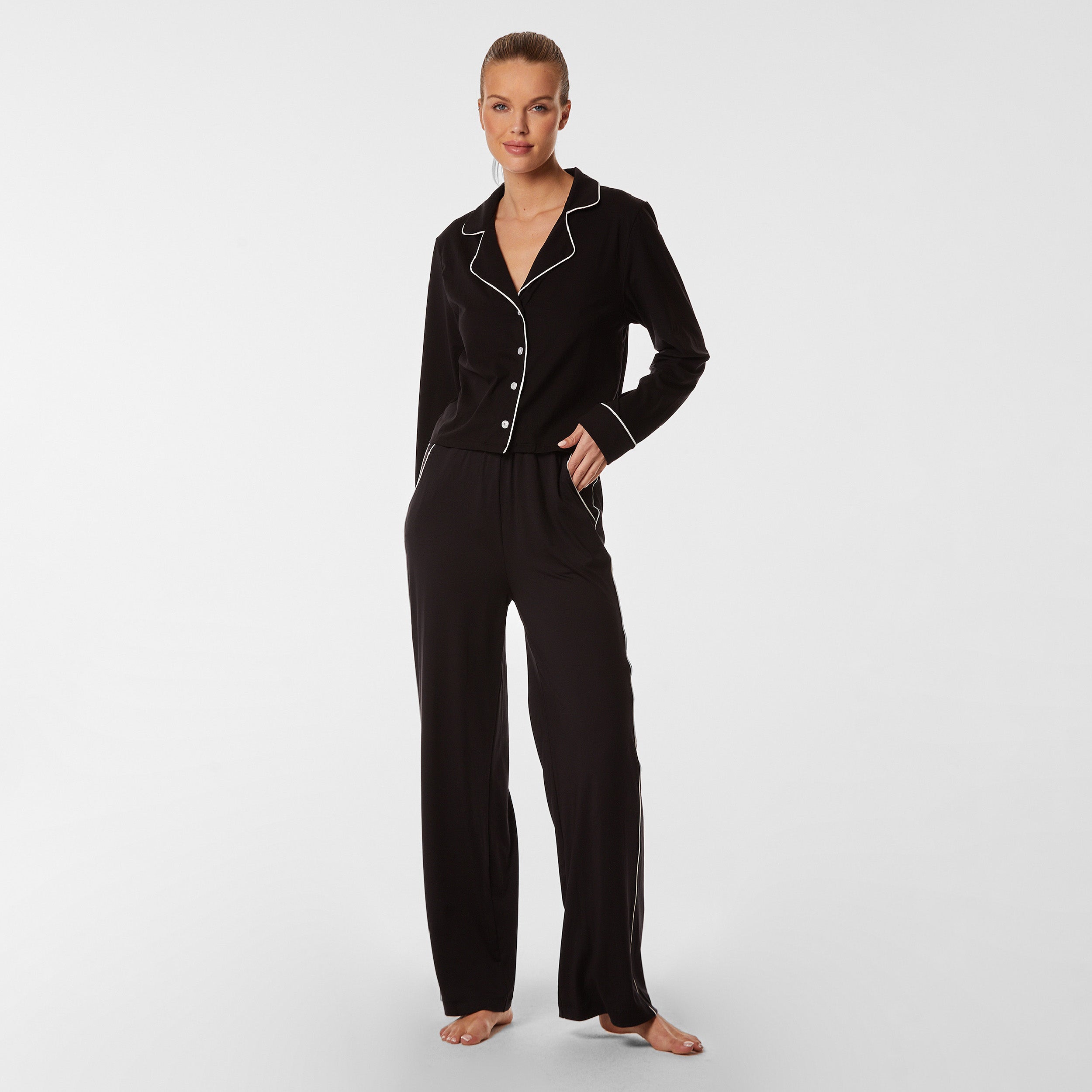 Full body front view of woman wearing soft Black Pajama set.