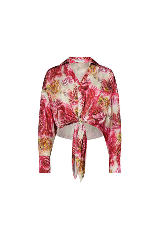 The Cecilia Silk Tie-Front Blouse - Bright Orchid is a lightweight, long-sleeve blouse featuring a pink, red, and yellow leaf print, collar, button-up front, and tie at the waist. Displayed on a white background.