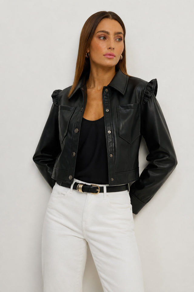 The Chantal Ruffle Sleeve Leather Jacket in black with snap buttons, chest pockets, and ruffled shoulders