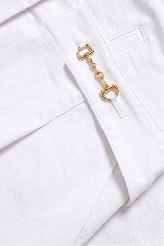 Close-up of the Ellery Horsebit Short in white, featuring a small pocket and decorative gold horsebit hardware—ideal for elevated summer style.
