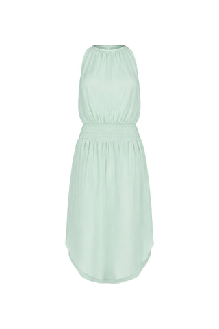 The Emelia Halter Dress in mint features a gathered neckline, elastic waistband, and slightly curved hem. Made from soft, flowy fabric for a relaxed summer look. Shown on a white background.