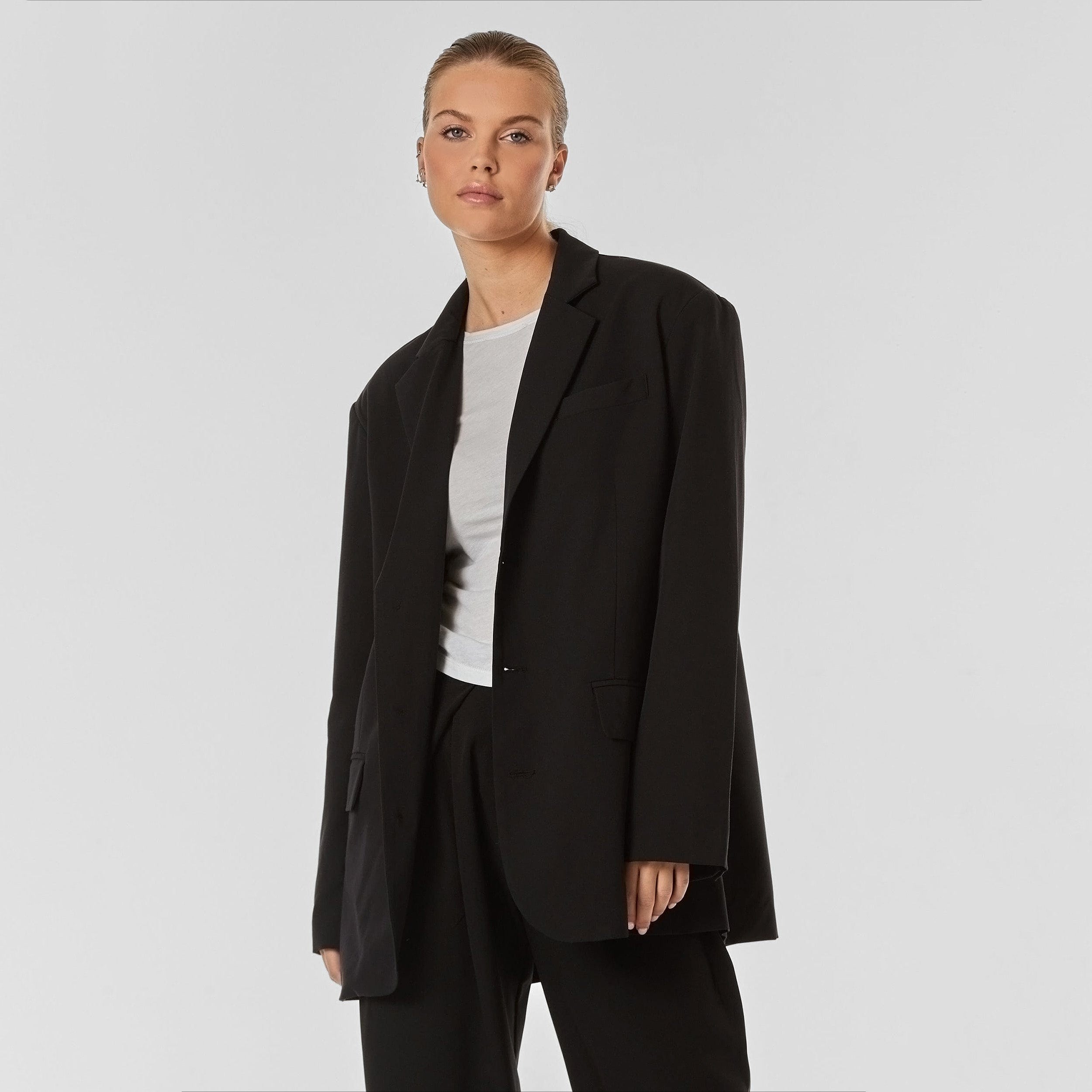 Woman wearing oversized black blazer.