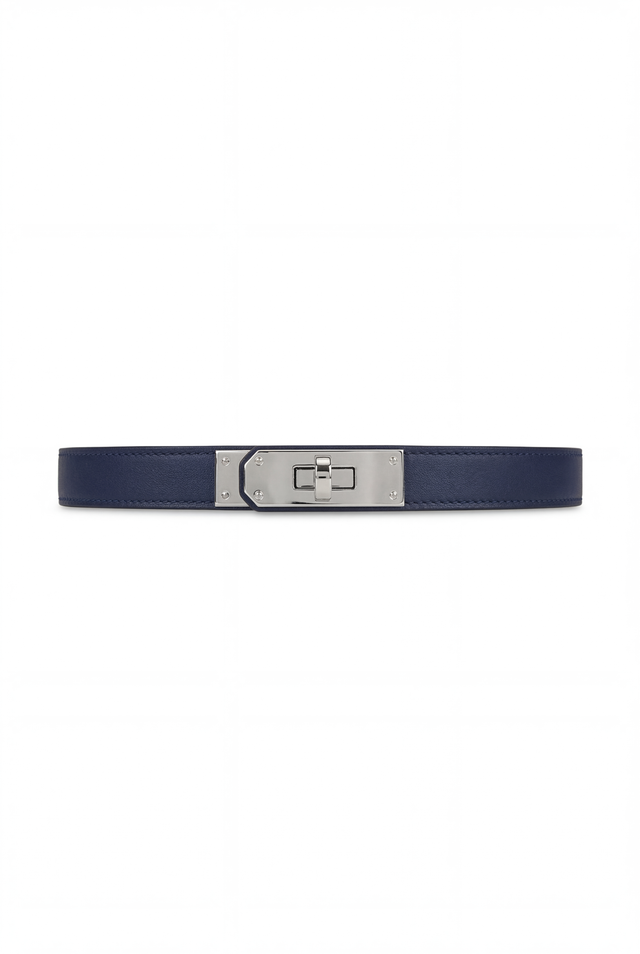The Nicola Belt - Navy is a vegan leather belt with a silver rectangular buckle and lock closure, shown on a plain white background.