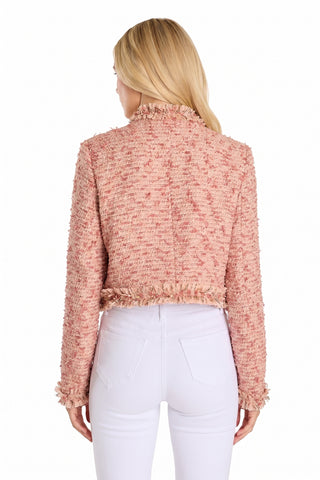 A woman with long blonde hair, seen from the back, wears the Florence Tweed Jacket - Rose Multi with a fringe hem and high-waisted white pants—a chic summer layer against a white background.