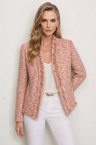 A woman with long wavy blonde hair models the Florence Tweed Jacket - Rose Multi over a white top and pants, posing against a light background with one hand on her hip.