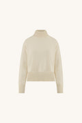 Gia Sweater in Pearl flat lay, ivory oversized turtleneck sweater on a cream background