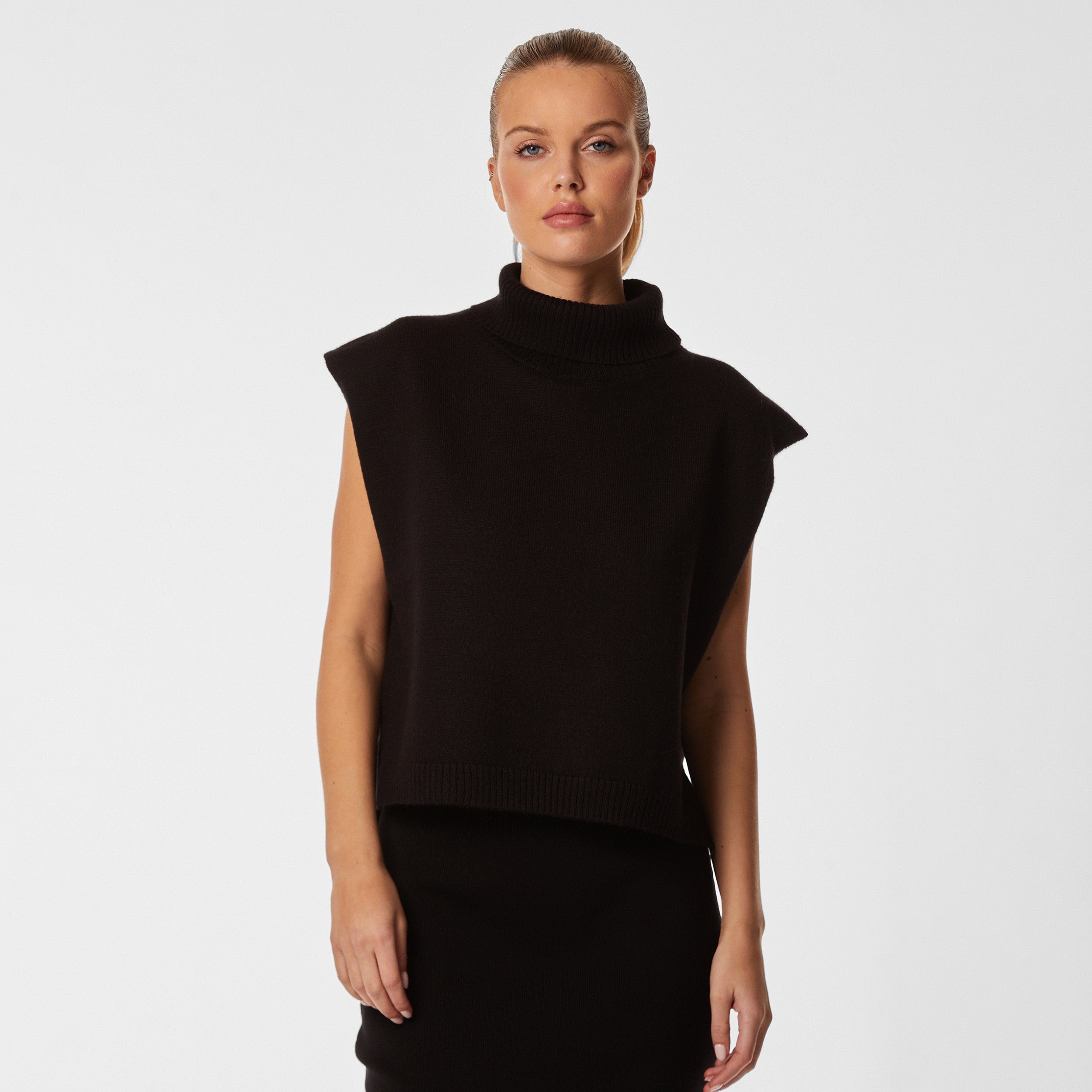 Woman wearing black sleeveless sweater