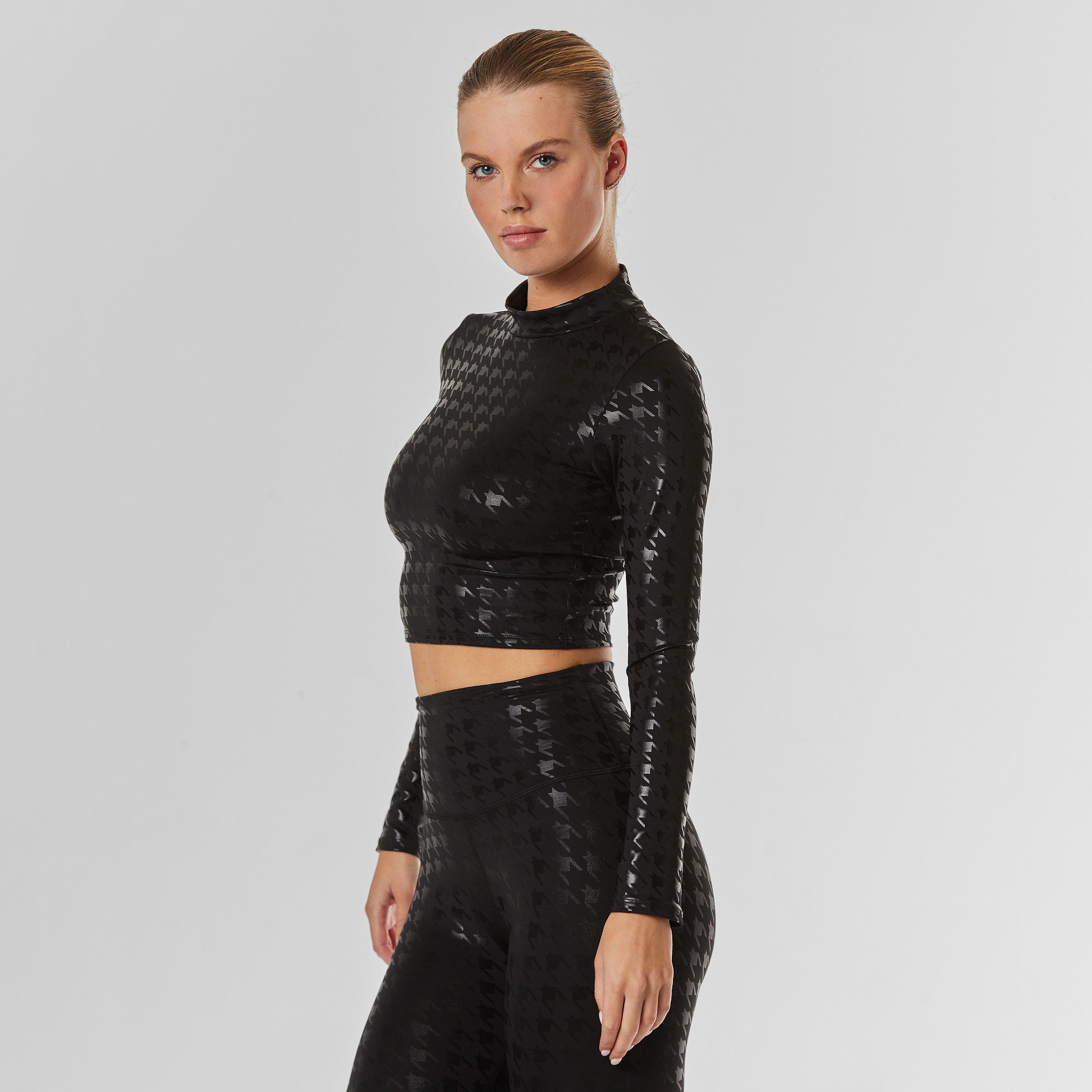 Side view of black on black houndstooth Long Sleeve top