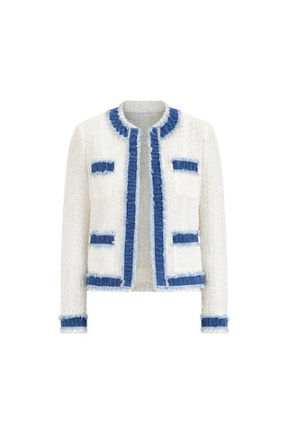 The Julia Tweed Jacket - Denim/White features long sleeves, white tweed fabric, blue denim trim, and fringe accents on the collar, front opening, hem, cuffs, and four front pockets.