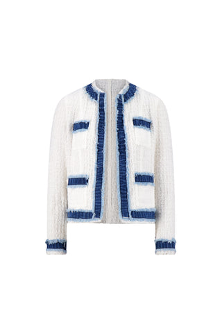 The Julia Tweed Jacket - Denim/White features a white textured tweed fabric with blue denim trim on the edges and pockets, long sleeves, a boxy fit, and an open-front, collarless design.