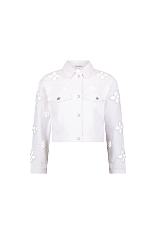 The Kaia Pearl Jean Jacket in white features a modern cropped silhouette, long sleeves, front button closure, two chest pockets, and floral cutout eyelet designs on the shoulders and sleeves. Displayed on a plain white background.
