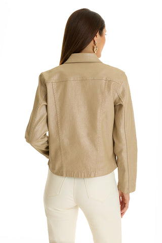A woman with long brown hair, wearing gold earrings and the Joelle Jean Jacket in Champagne, pairs it with high-waisted white pants as she stands with her back to the camera against a white background.