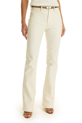 A person wearing the Aria Coated Flare Jean in Vanilla with a beige belt and brown heeled sandals. Their upper body and head are not shown.