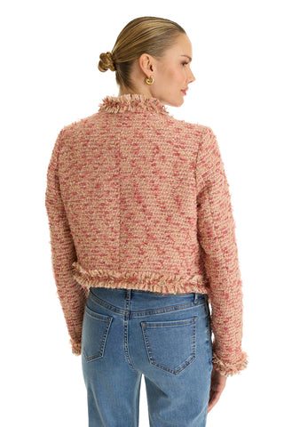 A blonde woman with a sleek bun wears the Florence Tweed Jacket - Rose Multi, featuring a fringe hem, styled with blue jeans and shown from the back against a white background.