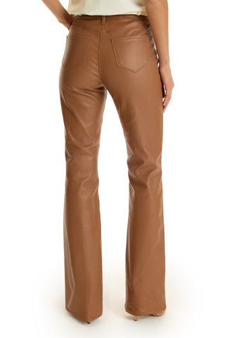 A person is seen from the back wearing the Aria Coated Flare Jean in mocha, featuring a high-rise fit, two back pockets, slim bootcut with flared legs, and paired with beige heels.