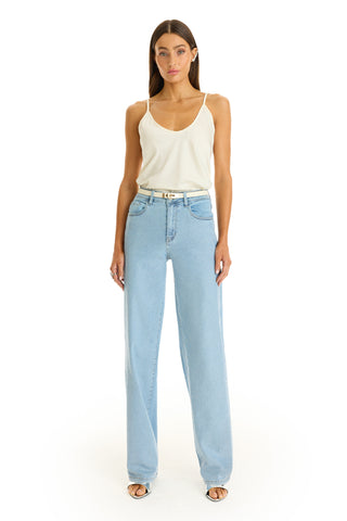 A woman faces forward wearing a white tank top, Brynn Crystal Jean - Medium Blue high-waisted wide-leg denim, and open-toe heels against a plain white background.