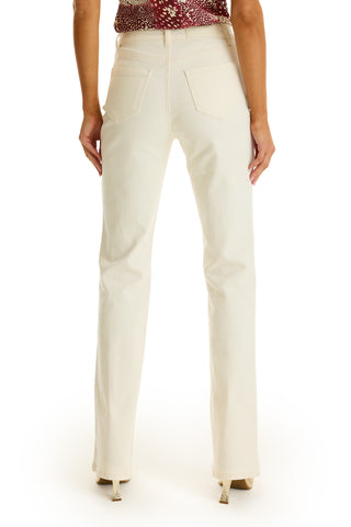 A person’s legs in the Aubrey Bootcut Jean in Ivory.