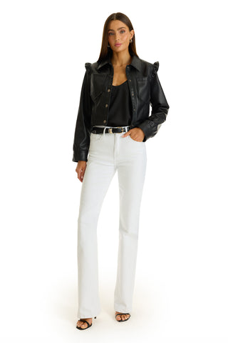 A woman stands against a white background wearing the Chantal Ruffle Sleeve Leather Jacket in black, paired with a black top, white high-waisted pants, black belt and heels, gold hoop earrings, and straight brown hair—a chic fall statement look.