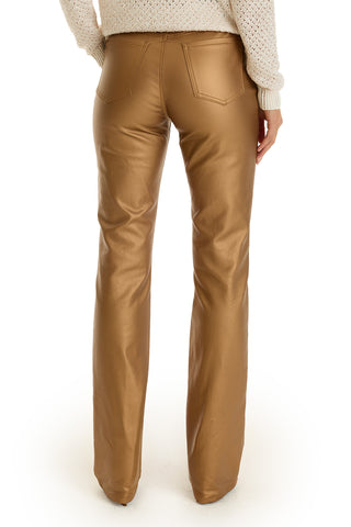 A person wearing the Aria Coated Flare Jean - Gold Metallic and a light knit sweater, shown from the back against a white background.