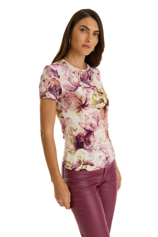 A woman with long brown hair wears the Amaya Ultra-Soft T-Shirt in French Garden print and matching maroon pants, standing against a white background and looking at the camera with a neutral expression.