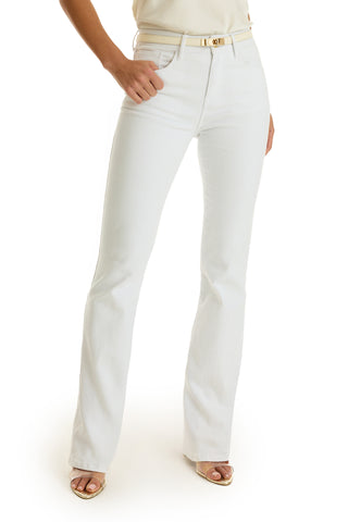 A person in white, high-waisted Aria Flare Jeans with a beige belt and open-toe sandals stands against a white background, one hand in their pocket.