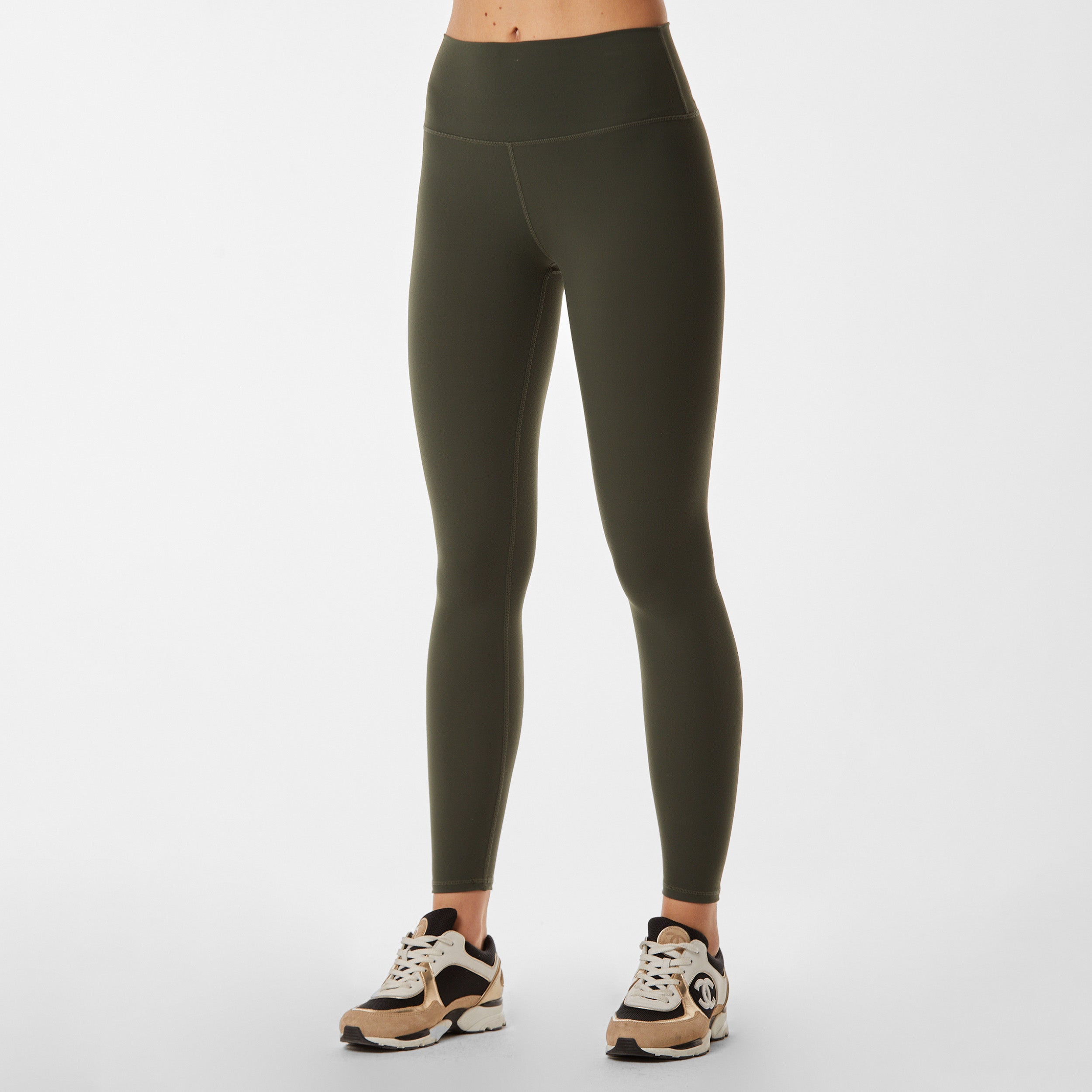 Front view of woman wearing sculpting and flattering green legging