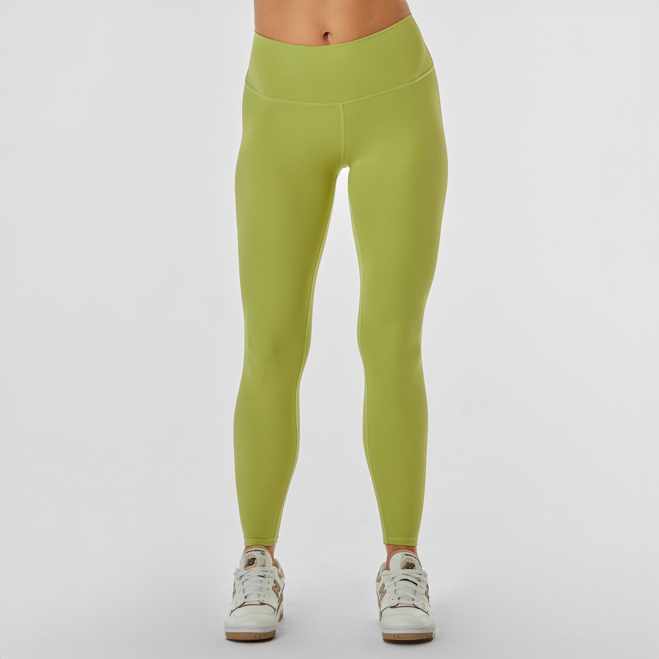 Front view of woman wearing sculpting and flattering light green legging