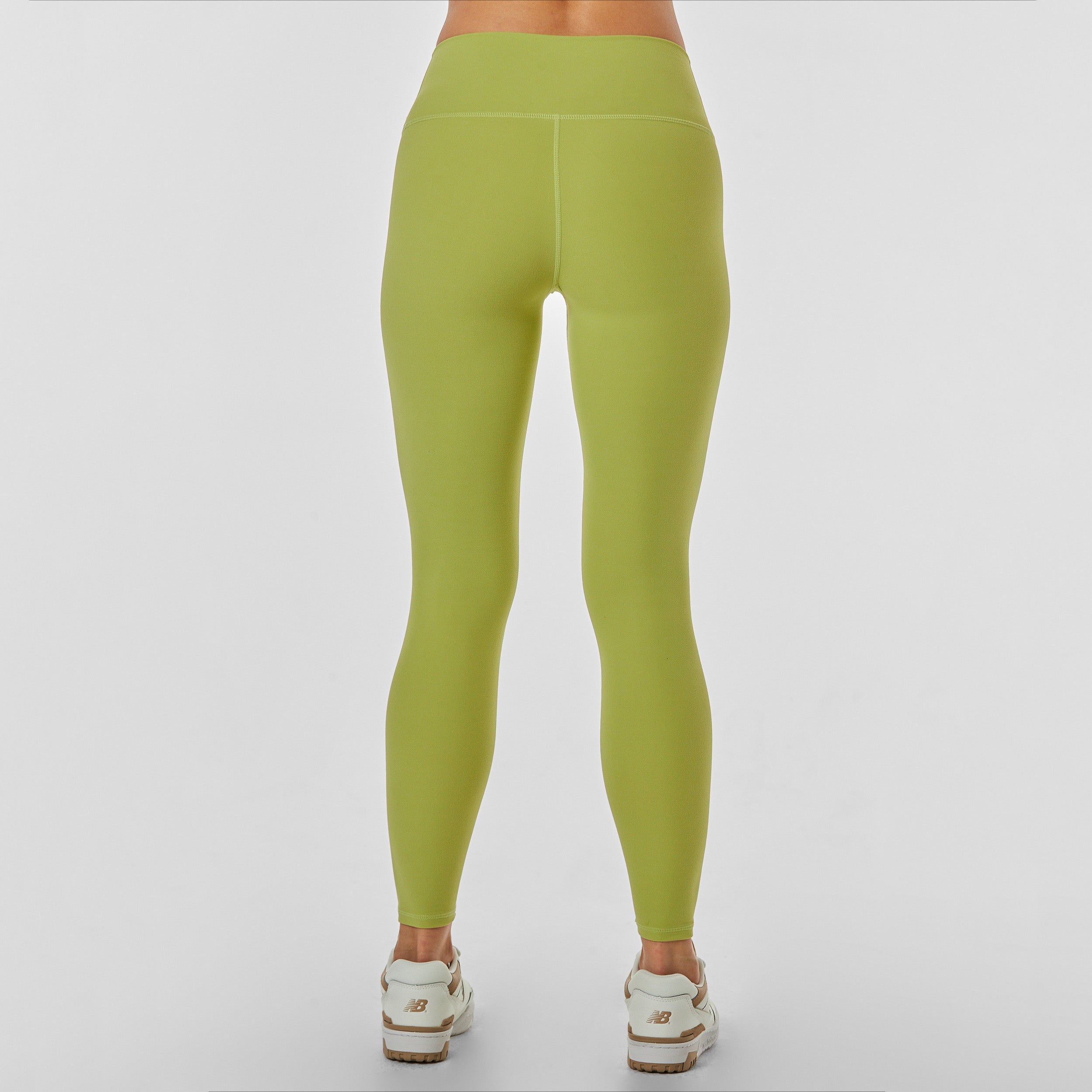 Rear view of woman wearing sculpting and flattering green legging