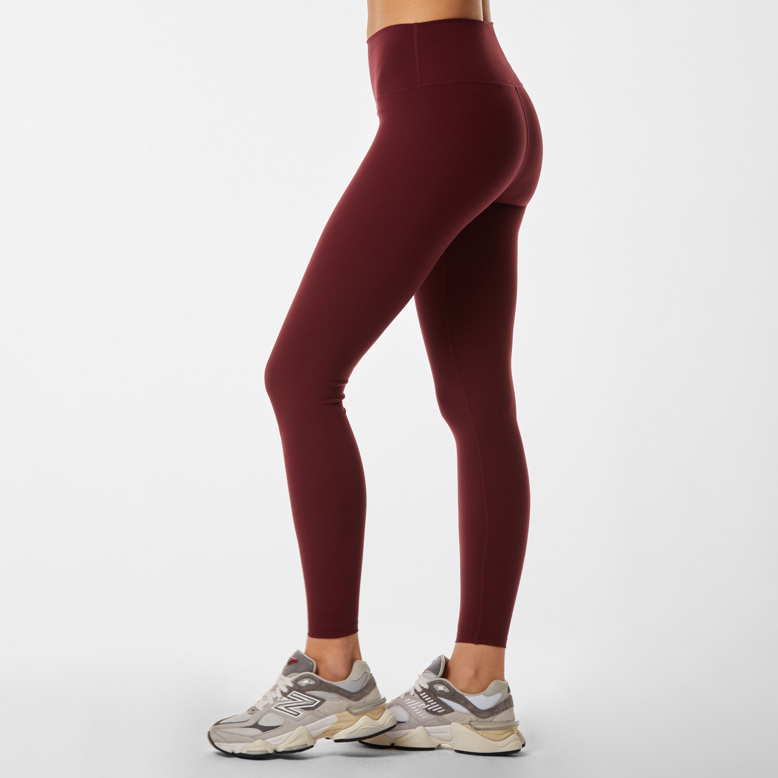 Side view of woman wearing sculpting and flattering red legging